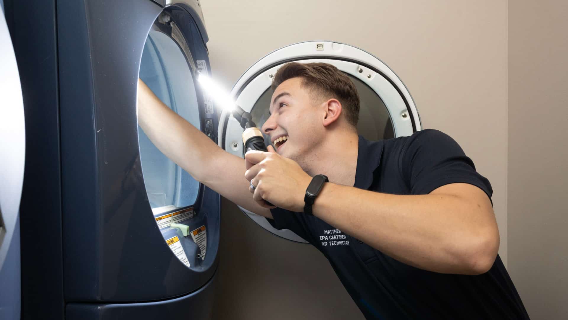 Best Day Appliance technician repairing a cooktop
