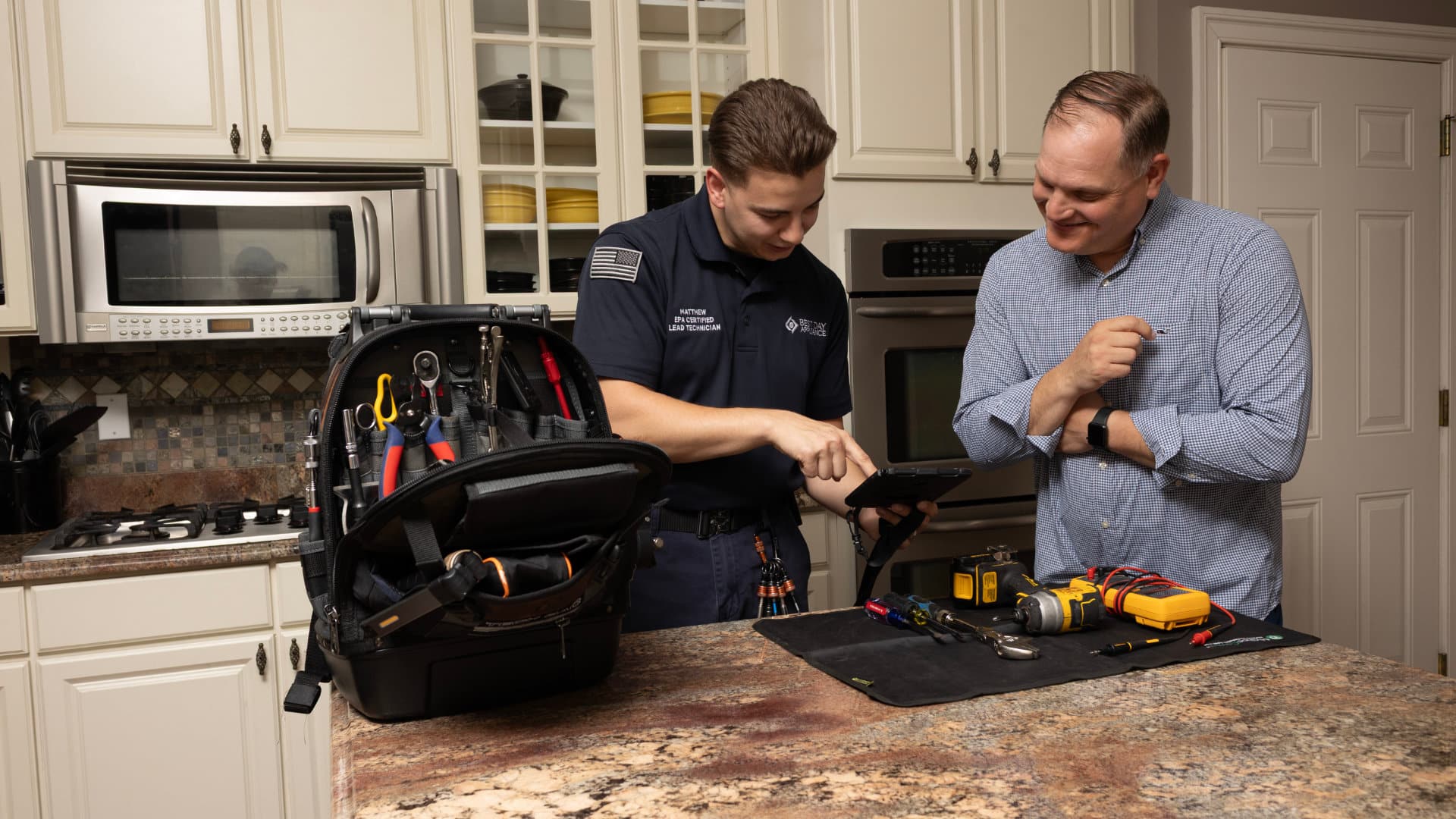 Best Day Appliance technician repairing a kitchen appliance